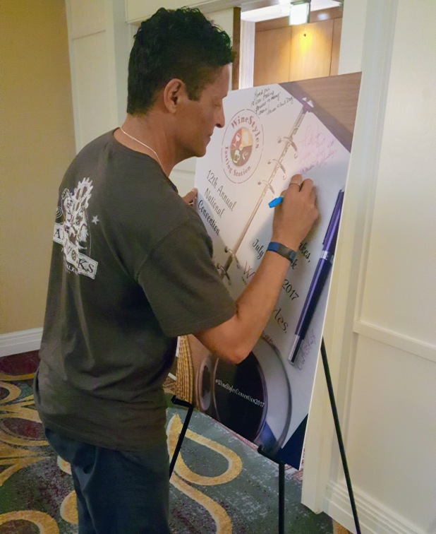 Bob signing the annual Convention poster